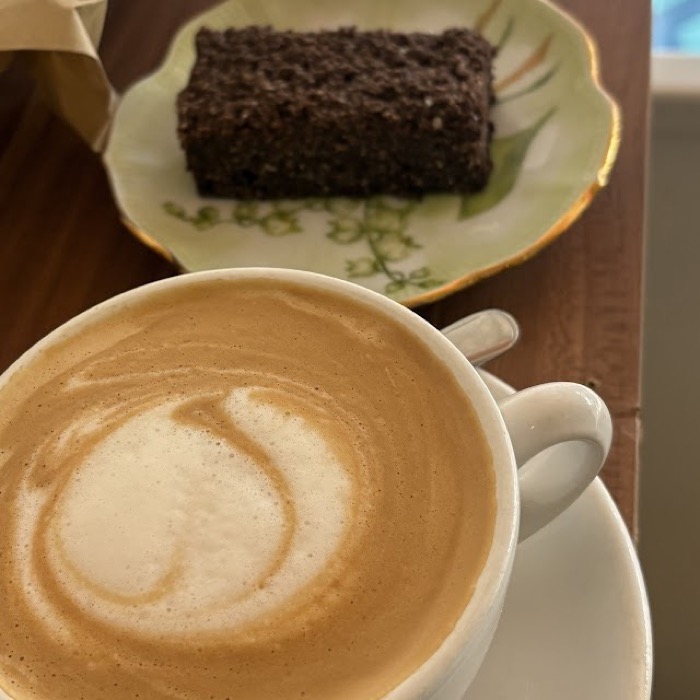A flat white and a slice of cake